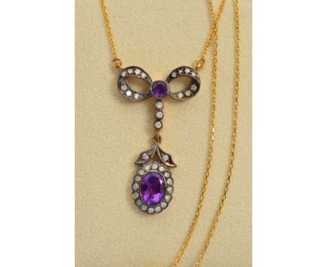 AN AMETHYST AND DIAMOND PENDANT, designed as a bow set with brilliant cut diamonds and central circular amethyst suspending a