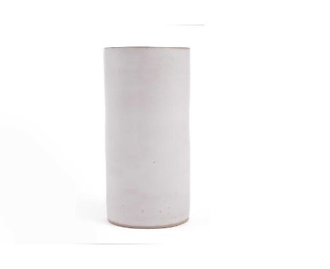 Dame Lucie Rie (1902-1995): a cylindrical stoneware beaker vase, with thick cream-coloured glaze and manganese rim, moulded m