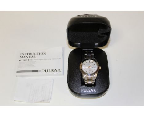 A BOXED PULSAR KINETIC 100 METRES DAY DATE WRISTWATCH AND INSTRUCTION MANUAL