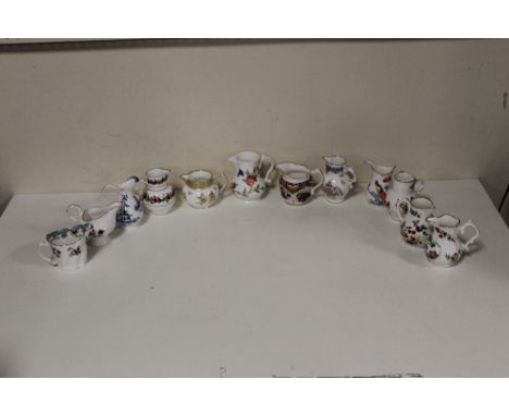 A COLLECTION OF TWELVE ROYAL WORCESTER CREAM JUGS