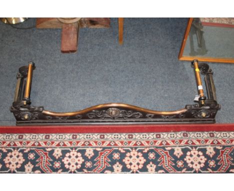 AN ART NOUVEAU CAST IRON AND COPPER FIRE FENDER, having various floral and organic embellishment, serpentine copper edged top