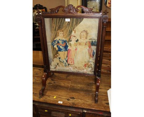 AN EARLY VICTORIAN MAHOGANY AND TAPESTRY EMBROIDERED FIRE SCREEN, the embroidered panel depicting a classical figural scene o