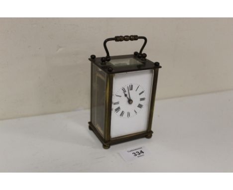 A VINTAGE BRASS AND GLASS CARRIAGE CLOCK 