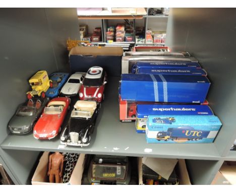 A shelf of modern diecasts including 12 Corgi Superhaulers and similar boxed diecasts, 1:18 scale Burago and Maisto models et