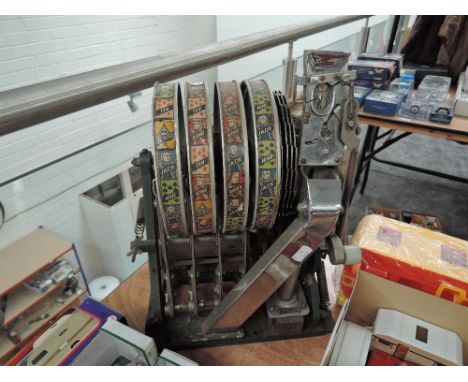 A vintage slot machine Mechanism by Aristocrat, Lucky Seven and Playing Cards seen
CONDITION REPORT
Plastic Lug pushed down a