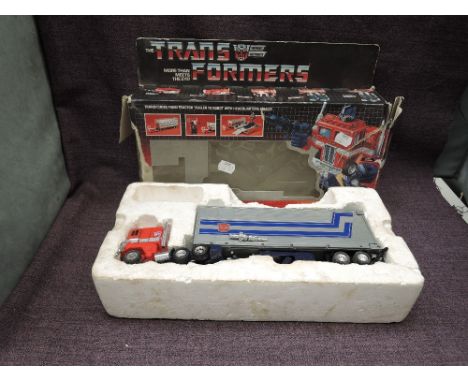 A 1984 Hasbro Bradley Transformers Autobot Commander Optimus Prime, in inner packaging with instruction leaflet with original