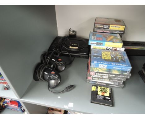 A Sega Mega Drive 16-Bit Console with 19 Game Cartridges in original plastic boxes with instruction booklets including Fatal 