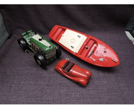 A Schuco Examico 4001 clockwork and tin plate car with key, Triang plastic model Cruiser Boat and a Marx tin plate and clockw