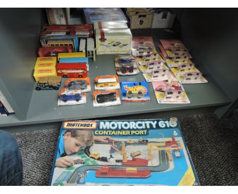 A shelf of 1980's and later Matchbox diecasts including Motorcity G10 Container Port, Thunderbirds Lady Penelopes Rolls Royce