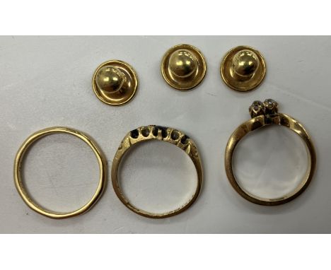 An 18 carat gold plain wedding band, size P, an 18 carat gold sapphire and diamond five stone ring, size N/O and an 18 carat 