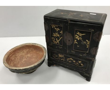 A 19th Century Japanese black lacquered and gilt decorated table top cabinet with two doors enclosing a bank of six drawers o