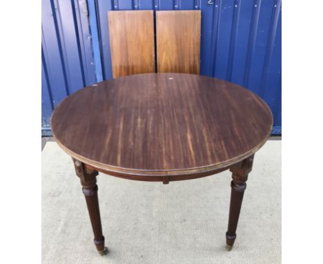 A circa 1900 mahogany D end dining table by James Shoolbred, the plain top with moulded edge above a plain frieze on slender 