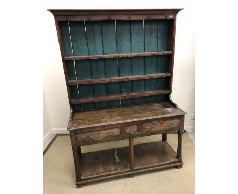 An 18th Century elm and fruitwood dresser, the three tier boarded plate rack with iron cup hooks and petrol blue painted back