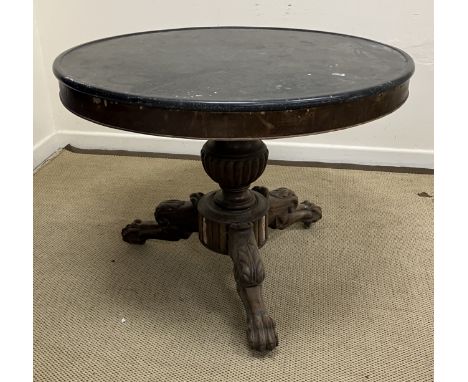 A late 19th Century French Empire style centre table, the black marble top with slightly raised edge over a plain frieze on a