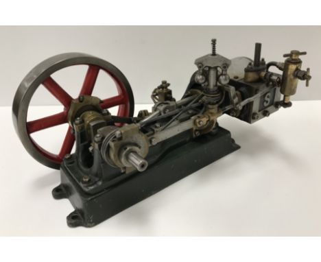 A Stuart Turner No. 9 stationary engine with large red fly wheel 27 cm long.