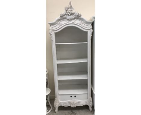 A modern white painted shelf unit in the Louis XV taste with adjustable shelving over a single drawer, 80 cm wide x 44 cm dee