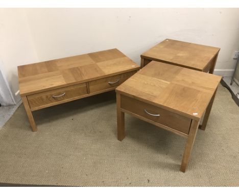 A modern oak two drawer coffee table on rectangular section supports, 57 cm x 107 cm x 40 cm high together with a pair of mat