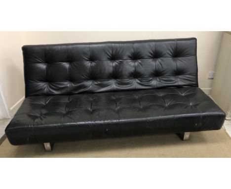 A modern black leather sofa on chromed legs, the back folding down to convert to a bed, 184 cm wide x 92 deep (with back upri