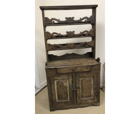 An 18th Century Italian chestnut dresser, the three tier plate rack with fretwork carved decoration over a single drawer and 