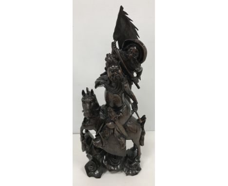 A circa 1900 Chinese carved wood and silver wire inlaid figure group of a horse mounted warrior and flag bearing attendant, t