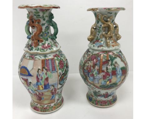 A 19th Century Chinese Canton famille rose vase, the flared rim with margarite decoration, the neck decorated in high relief 