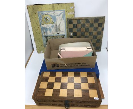 A Chinese carved soapstone chess set together with a Korean resin chess set and travelling backgammon set and another carved 