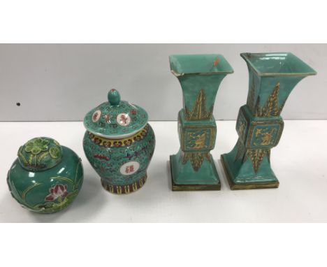 A pair of Chinese turquoise glazed gu vases of flared square form, the main bodies decorated with acanthus and panels of exot
