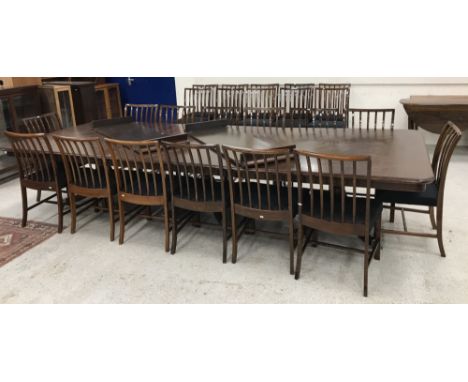 A modern mahogany triple pillar dining or board room table in the Georgian style on splayed quadruped bases to lion's paw cap