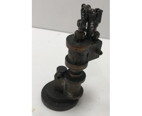 A small Stuart Turner type brass steam engine on circular base 9.5 cm high