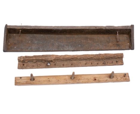 A rustic wooden shelf: with twin nail hooks, 111cm wide, two other rustic wooden bars with hooks, 89cm and 85cm wide, also a 