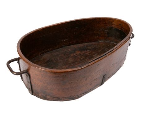 A large wooden trough: of pear-shaped outline with iron twin handles - the trough 56 x 38cm maximum, 18th Century.