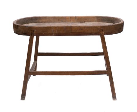 A 19th Century oval pine shallow trough: on integral stand with splayed legs, united by stretchers, 81.5 x 42cm.