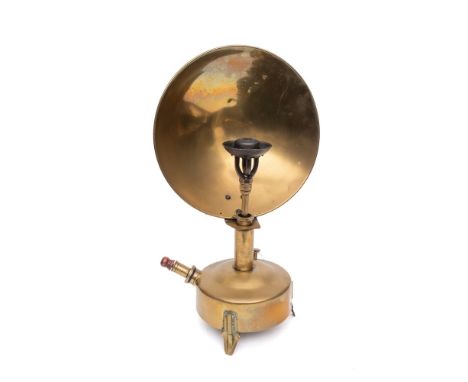 A brass reflector lamp: with concave shield and circular oil font.