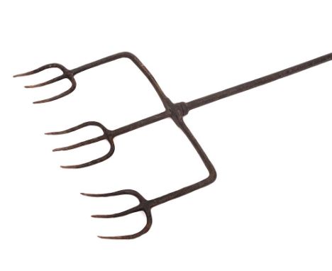 An iron triple pronged flesh fork:, each prong with three tines, the long handle with ring terminal, 121cm long, 18th Century