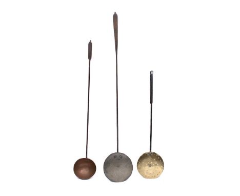 A copper and iron handled hanging ladle:, 94cm long, a brass and iron handled skimmer and a tinned ladle with hammered finish