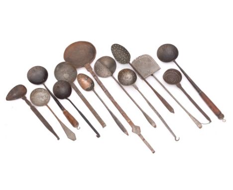 An iron long-handled hanging ladle: with brass banded inlaid handle together with a collection of twelve various ladles, siev