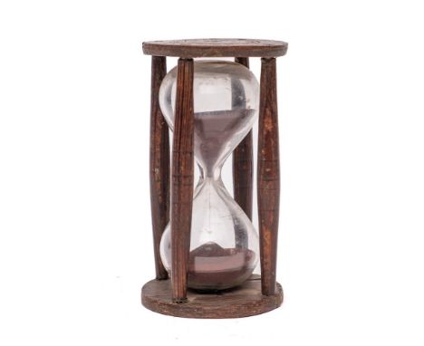 A 19th Century glass sand timer: in a circular wood stand with turned uprights.