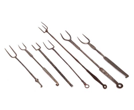 An iron three pronged flesh fork: and six various twin pronged toasting forks. (7)