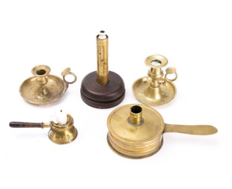 A brass circular chamber candlestick and cover: with handle, two circular brass chambersticks, a small chamberstick with wood