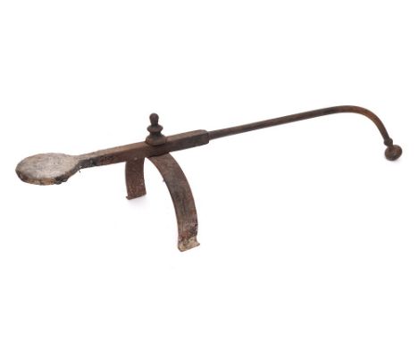 A wrought iron salamander: with turned finial on U-shaped support, 18th Century.