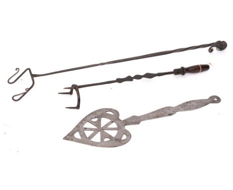A pierced steel heart-shaped skimmer: with shaped handle and ring terminal, a three pronged metal fork with turned wood handl