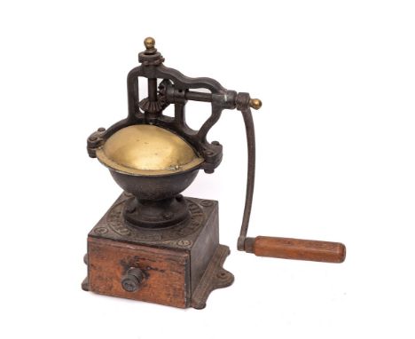 A French cast iron and brass coffee grinder: with wood drawer, the base inscribed 'Peugeot Freres Brevetes SGDC', 35cm high.