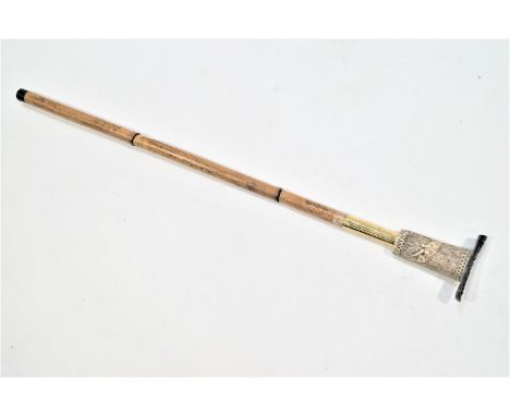 A heavy walking stick with faux ivory dog handle