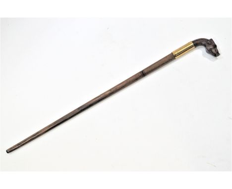 A heavy walking stick with a pigs head handle