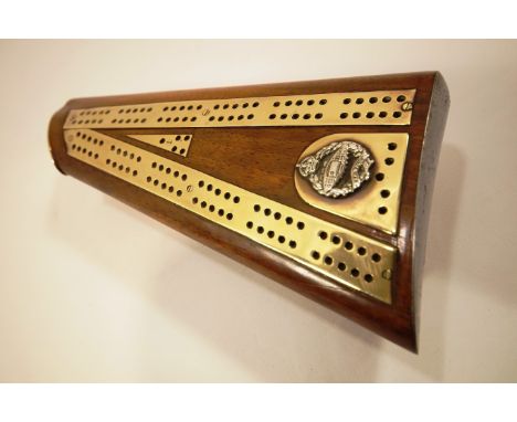 A trench art cribbage board, set on a gun stock with Tank Regiment crest, c 1920, standing on three bullet supports, 5cm high