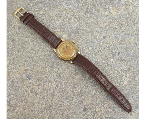 A mid-century 9ct gold cased gentleman's manual wind wrist watch by Rolex - the circular silvered dial with lumed Arabic nume