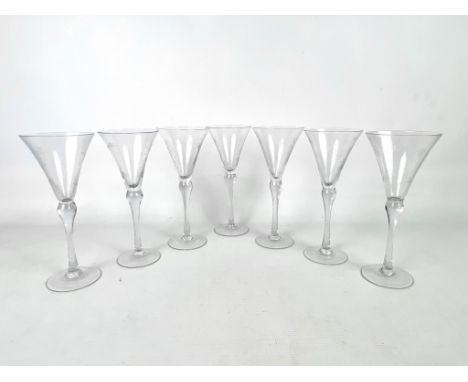 A set of seven 18th century style engraved wine glasses - first half 20th century, the flared trumpet bowls engraved with flo