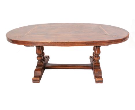 An elm and beech wood dining table in 18th century style&nbsp;- the oval elm top with moulded edge, the central rectangular p