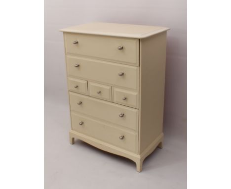 A modern cream-painted chest of drawers - 1970s, later painted and replaced handles, with four bevelled drawers and a central