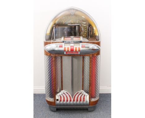 A late-1940s Wurlitzer Model 1100 'Bomber Nose' juke box - manufactured from 1947-49, serial no. 2105654, the cabinet veneere